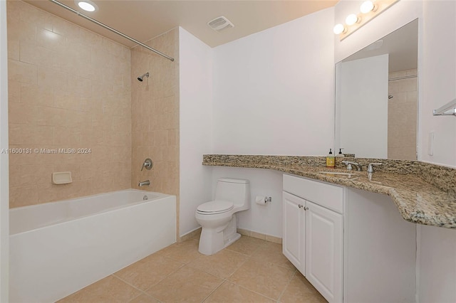 full bathroom featuring tile patterned flooring, vanity, toilet, and tiled shower / bath