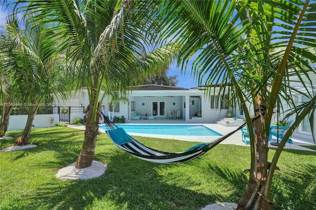 view of pool featuring ceiling fan, a yard, and a patio