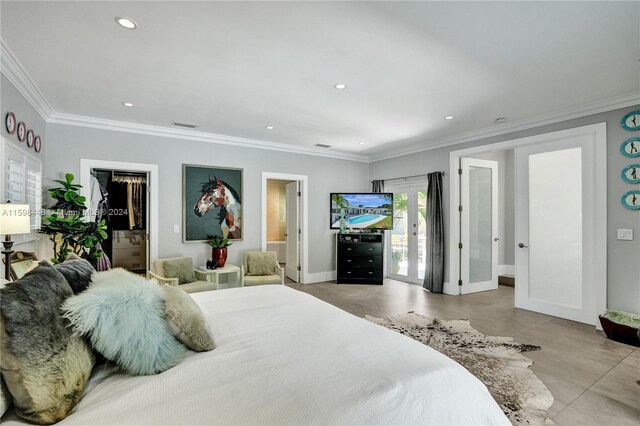 bedroom with a walk in closet, ornamental molding, access to outside, and french doors