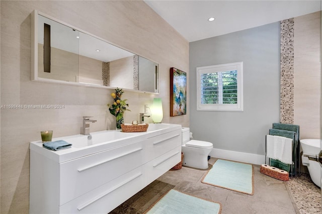 bathroom with tile patterned flooring, vanity, toilet, and tile walls