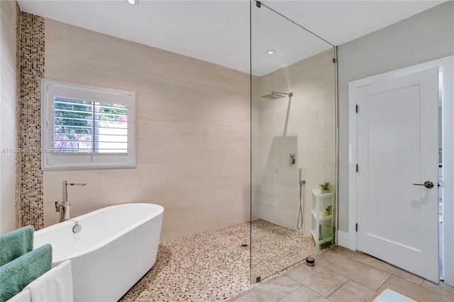 bathroom with independent shower and bath and tile walls