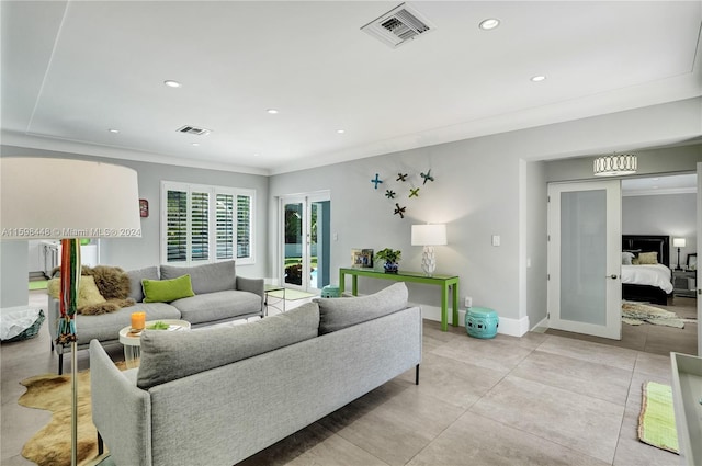 living room with light tile patterned floors, crown molding, and french doors