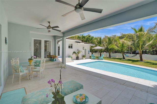 view of pool with ceiling fan, french doors, and a patio