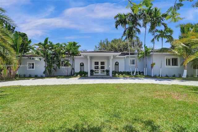 single story home with a front lawn and french doors