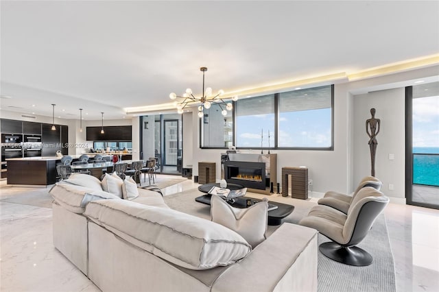 living room with a notable chandelier and light tile floors