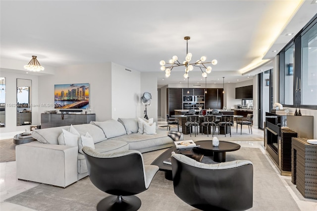 carpeted living room featuring an inviting chandelier