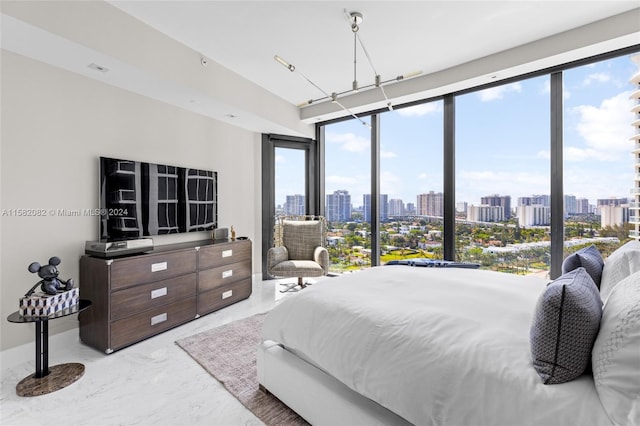 bedroom featuring floor to ceiling windows, concrete flooring, and multiple windows