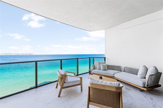 balcony with an outdoor hangout area and a water view