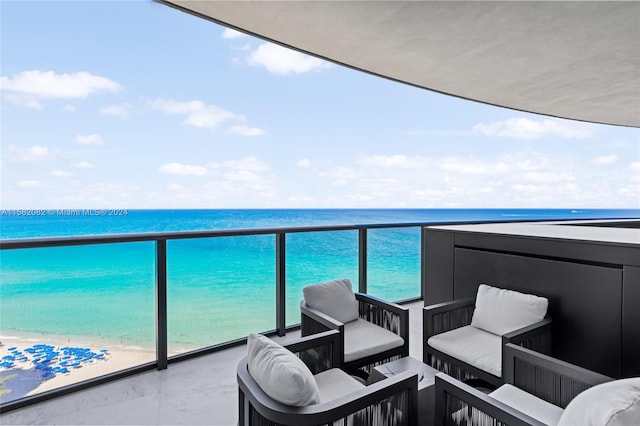 balcony with a beach view and a water view