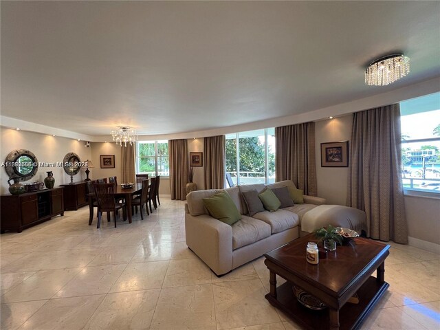 tiled living room featuring a notable chandelier