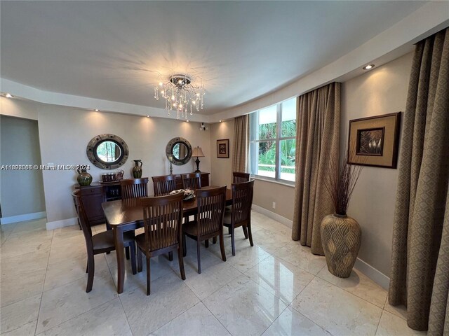 dining room with a notable chandelier and light tile floors