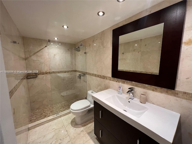 full bathroom featuring walk in shower, tile walls, toilet, and vanity