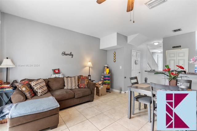 tiled living room with ceiling fan