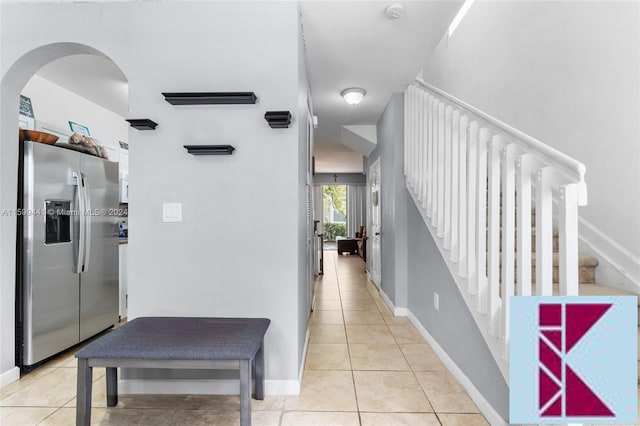 hall with light tile patterned floors