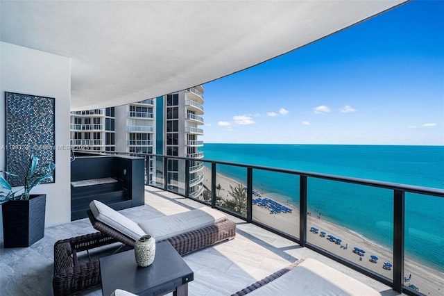 balcony with a beach view and a water view