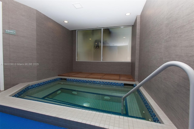 view of swimming pool featuring an indoor in ground hot tub