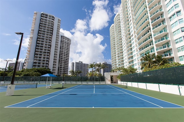 view of tennis court featuring basketball court