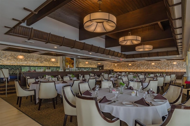 dining space with wood-type flooring, wooden ceiling, and a high ceiling