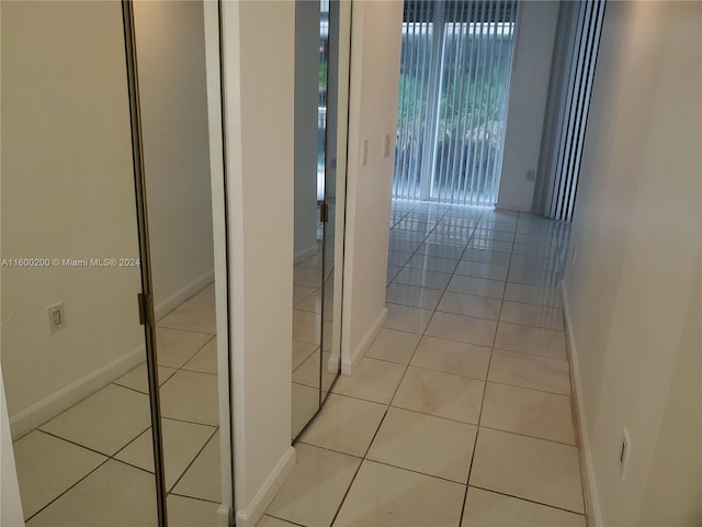 hall with light tile patterned floors