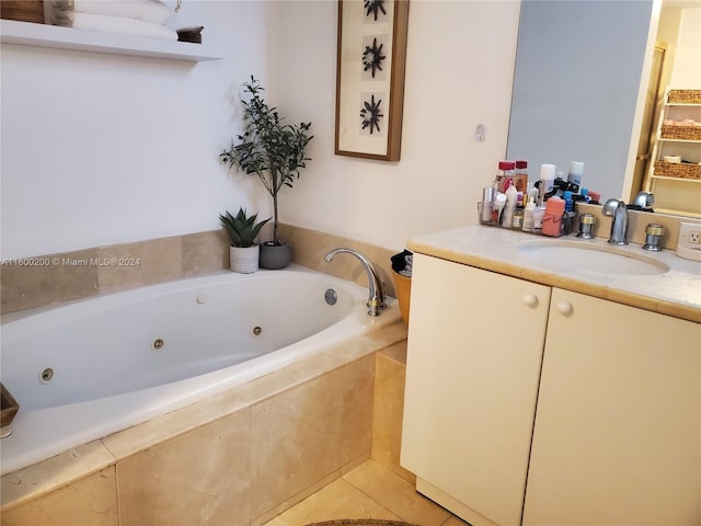 bathroom with tiled bath, tile patterned floors, and vanity