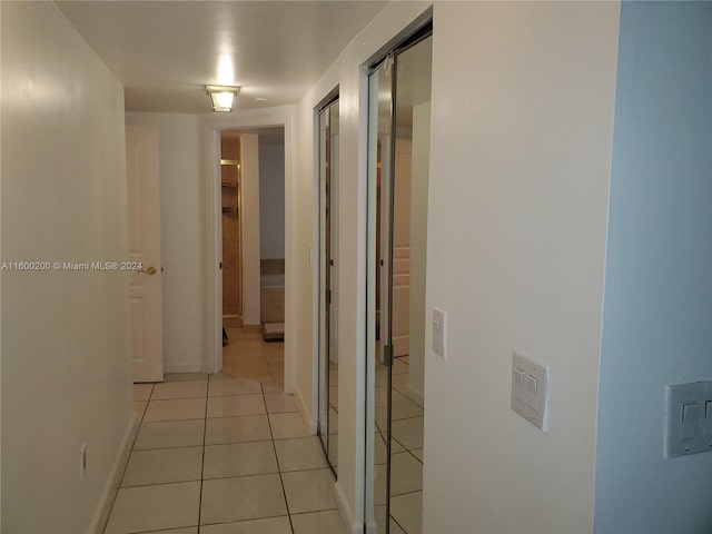 corridor with light tile patterned flooring