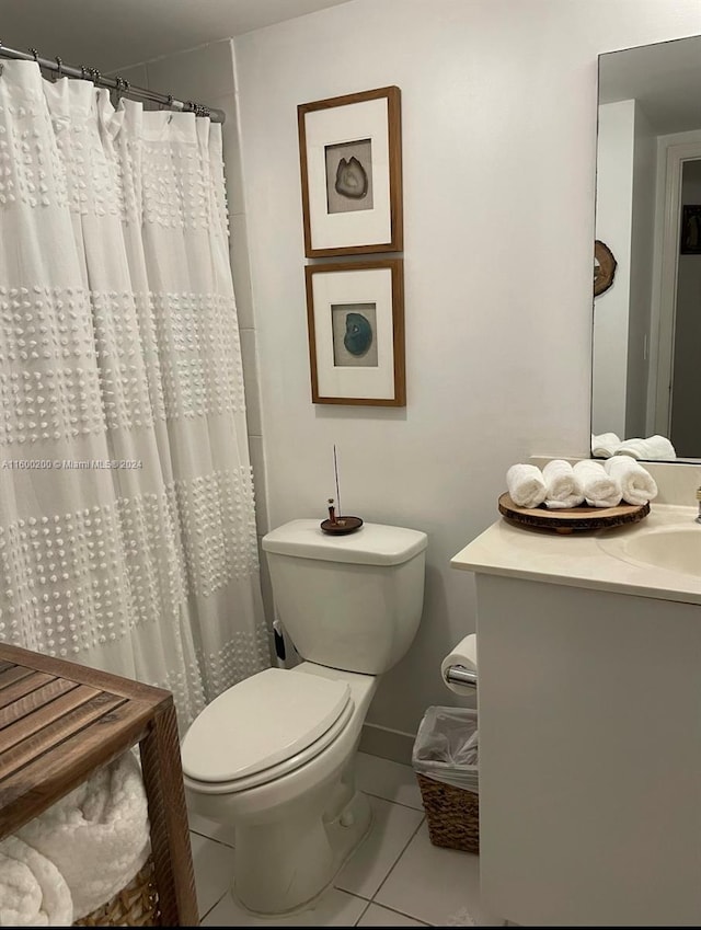 bathroom with toilet, vanity, curtained shower, and tile patterned floors