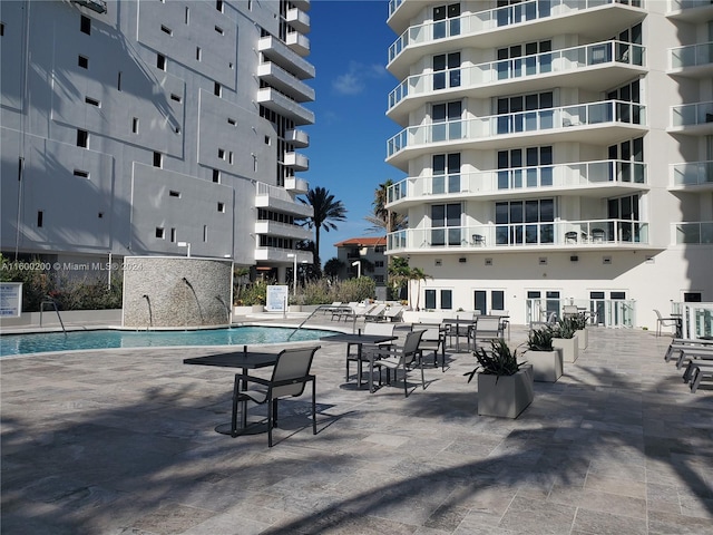 view of swimming pool with a patio