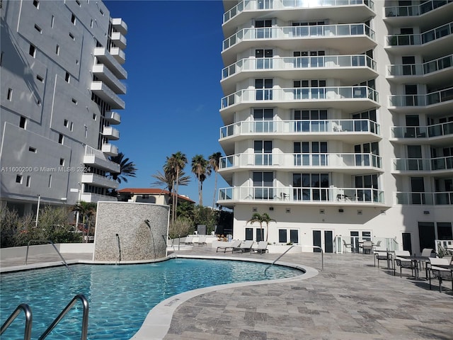 view of swimming pool featuring a patio area