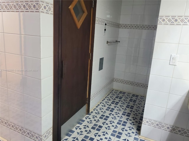 bathroom with tiled shower