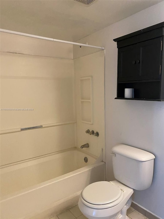 bathroom featuring tile patterned flooring, shower / bathtub combination, and toilet