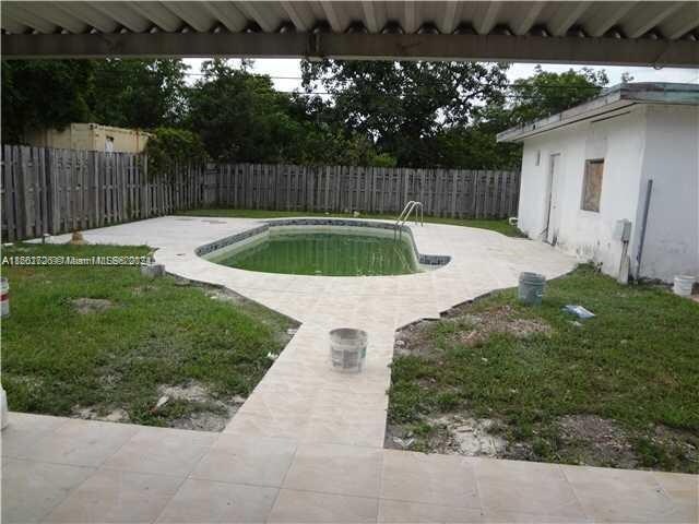 view of pool with a lawn and a patio