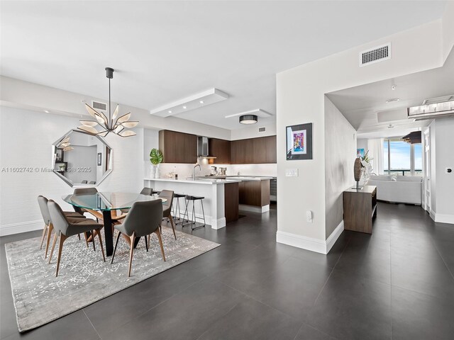 dining area featuring an inviting chandelier and sink