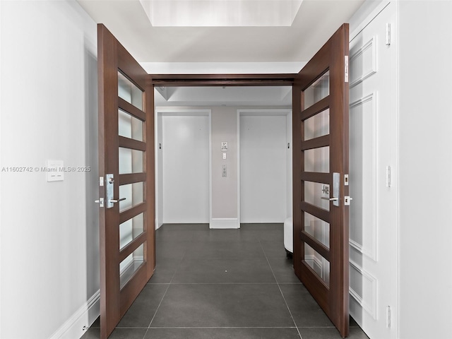 hallway featuring dark tile patterned flooring