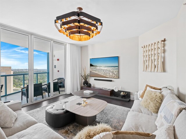 living room featuring hardwood / wood-style floors, expansive windows, and a chandelier