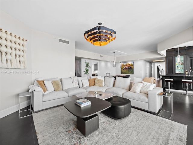 living room featuring hardwood / wood-style flooring and bar area