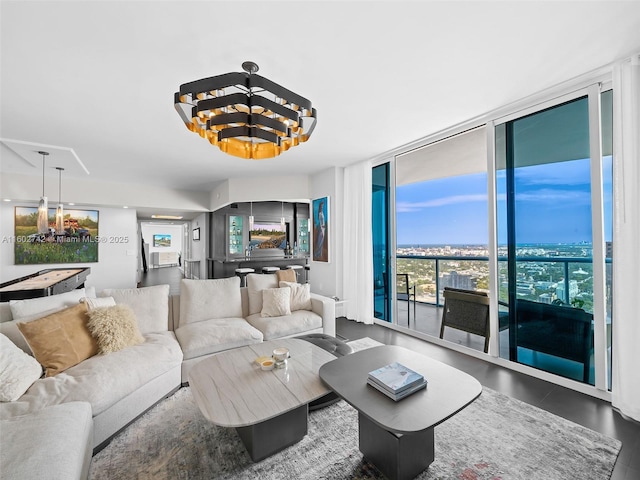 living room featuring a chandelier and a wall of windows