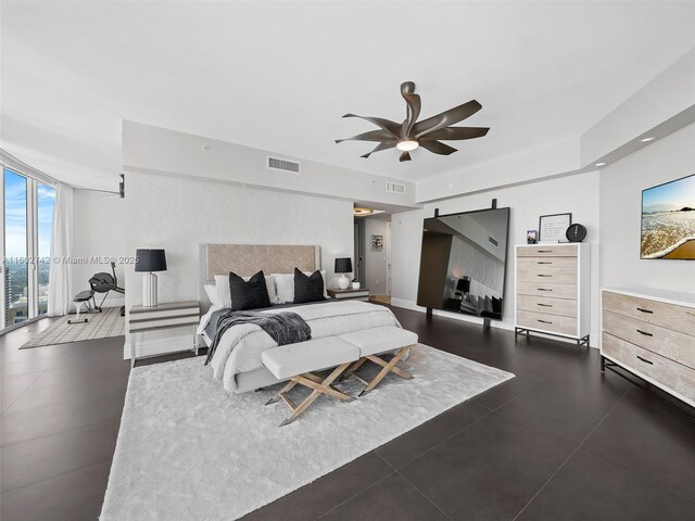 bedroom with a wall of windows and ceiling fan