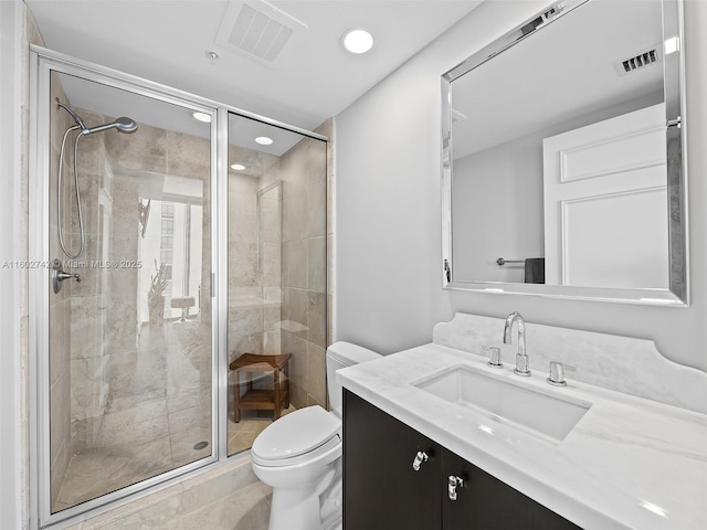 bathroom featuring an enclosed shower, vanity, and toilet