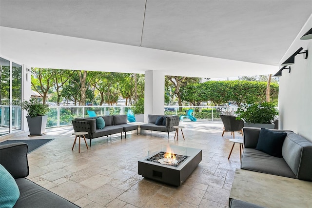 view of patio / terrace with an outdoor living space with a fire pit