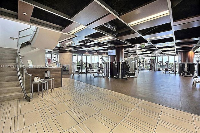 exercise room featuring coffered ceiling