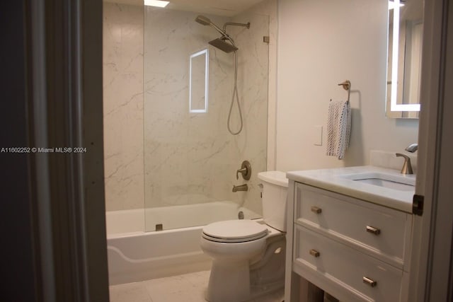 full bathroom with tile floors, oversized vanity, toilet, and tiled shower / bath combo