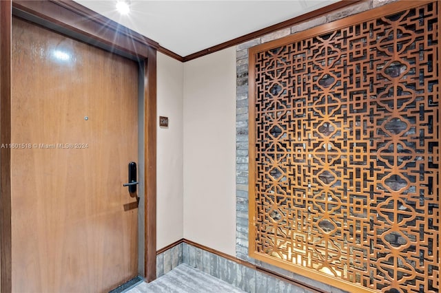 foyer featuring crown molding