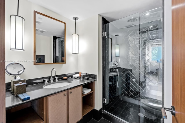 bathroom with vanity and a shower with shower door