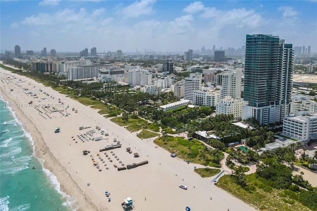 drone / aerial view featuring a beach view and a water view