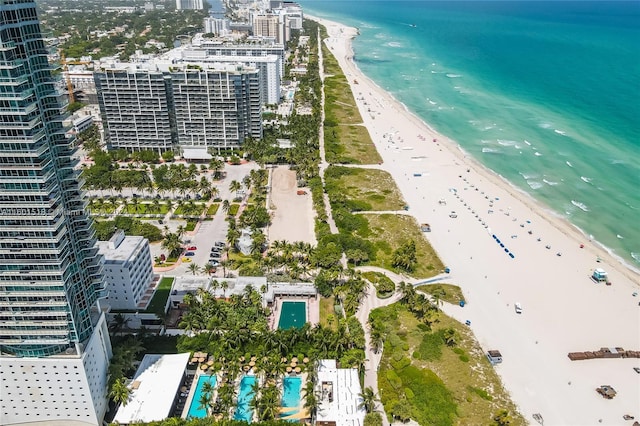 birds eye view of property featuring a beach view and a water view