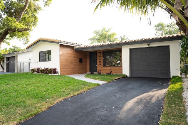 view of front of home featuring a garage and a front lawn