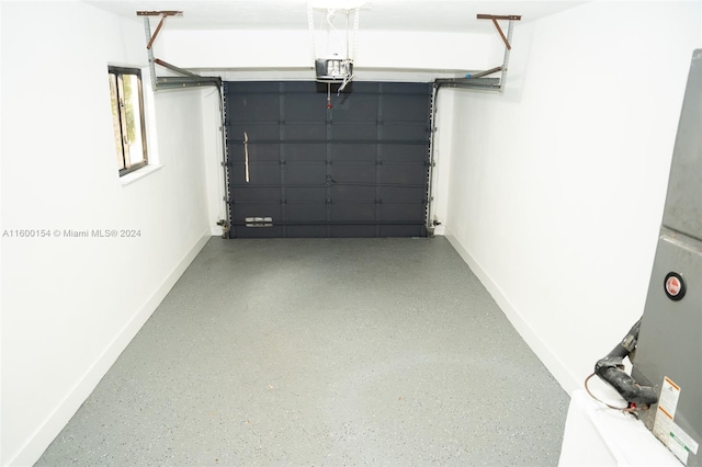 laundry area with heating unit, electric panel, washing machine and clothes dryer, and electric water heater