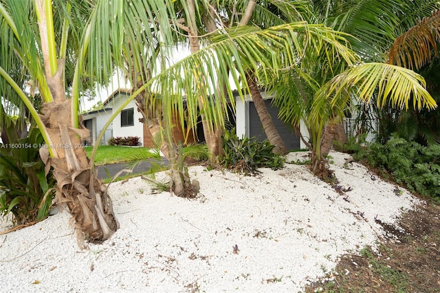 view of side of home with a yard