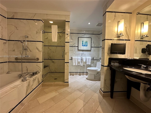 full bathroom featuring tile patterned flooring, shower with separate bathtub, toilet, and sink