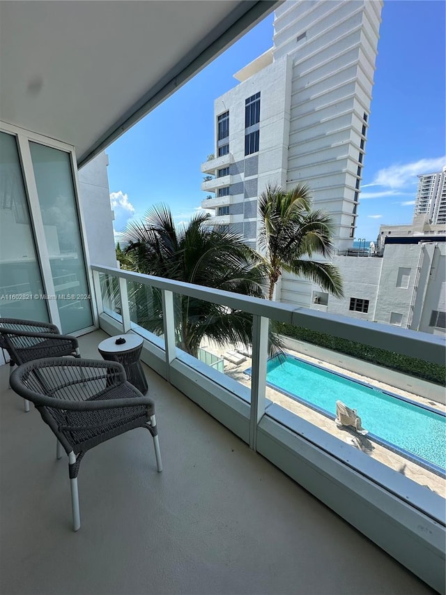 balcony with a fenced in pool